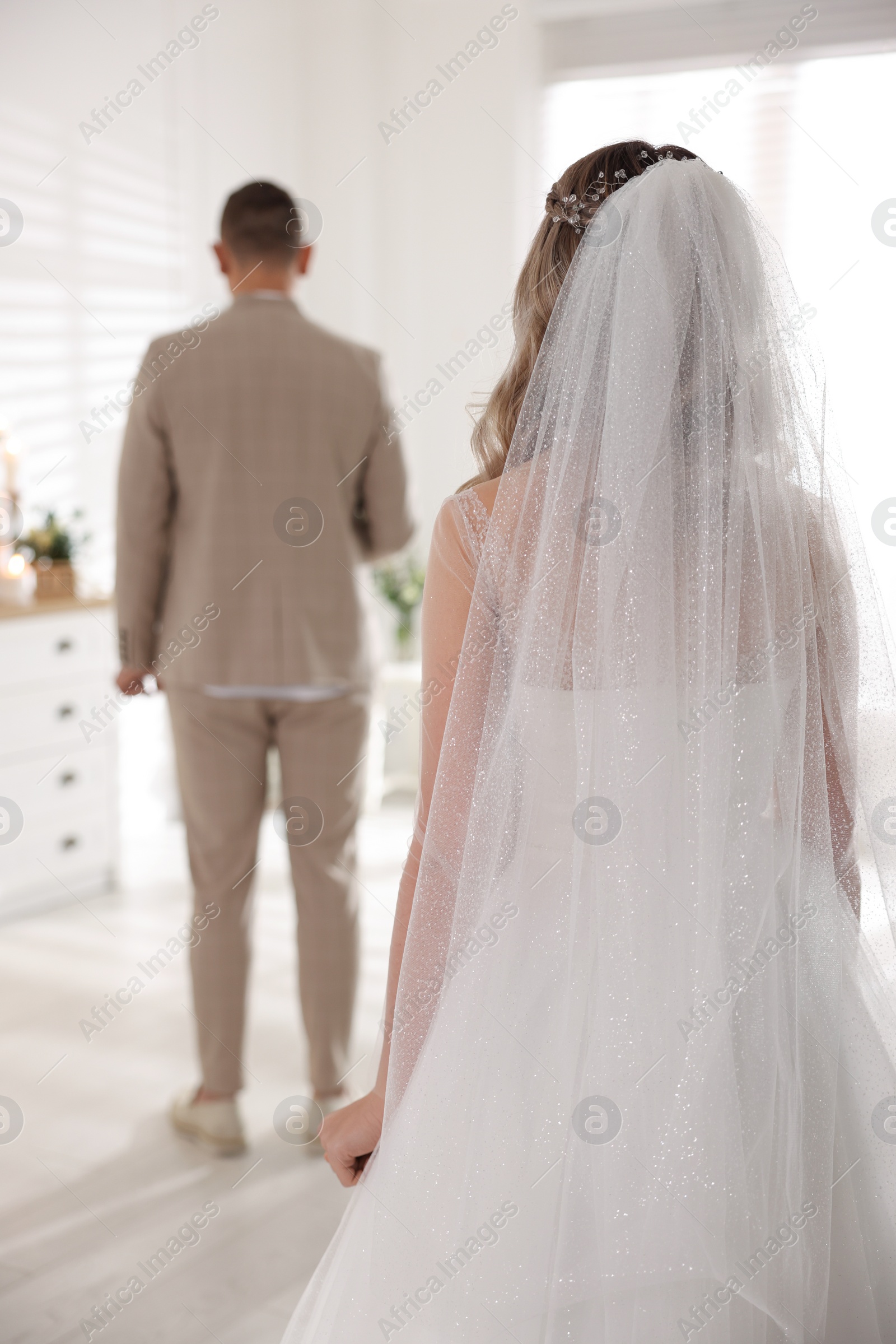 Photo of Groom waiting for his lovely bride, back view. First meeting at wedding day