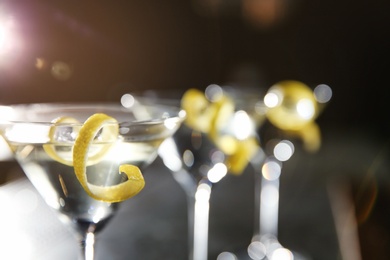 Photo of Glasses of lemon drop martini cocktail in bar, closeup. Space for text
