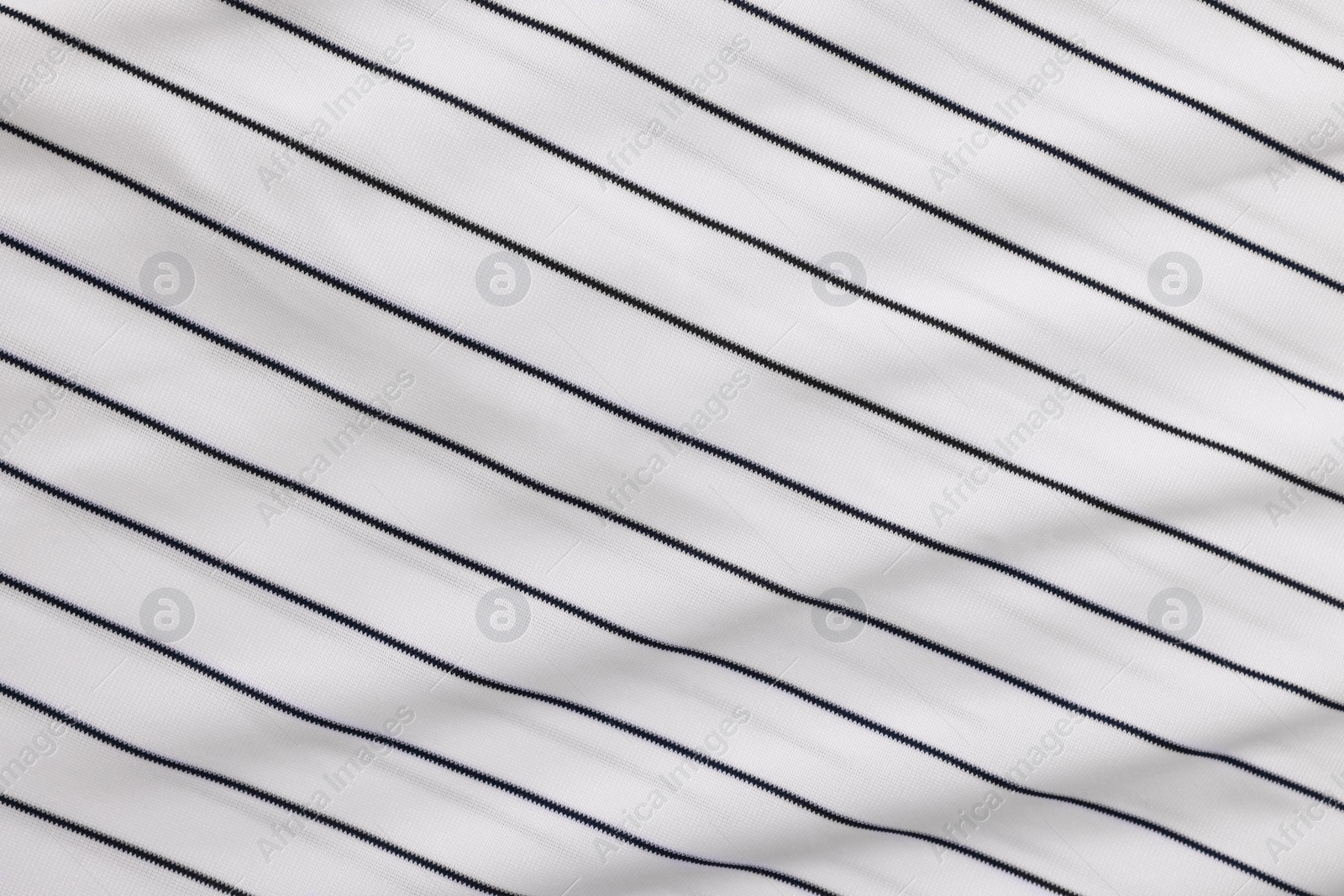 Photo of Striped baseball uniform as background, top view