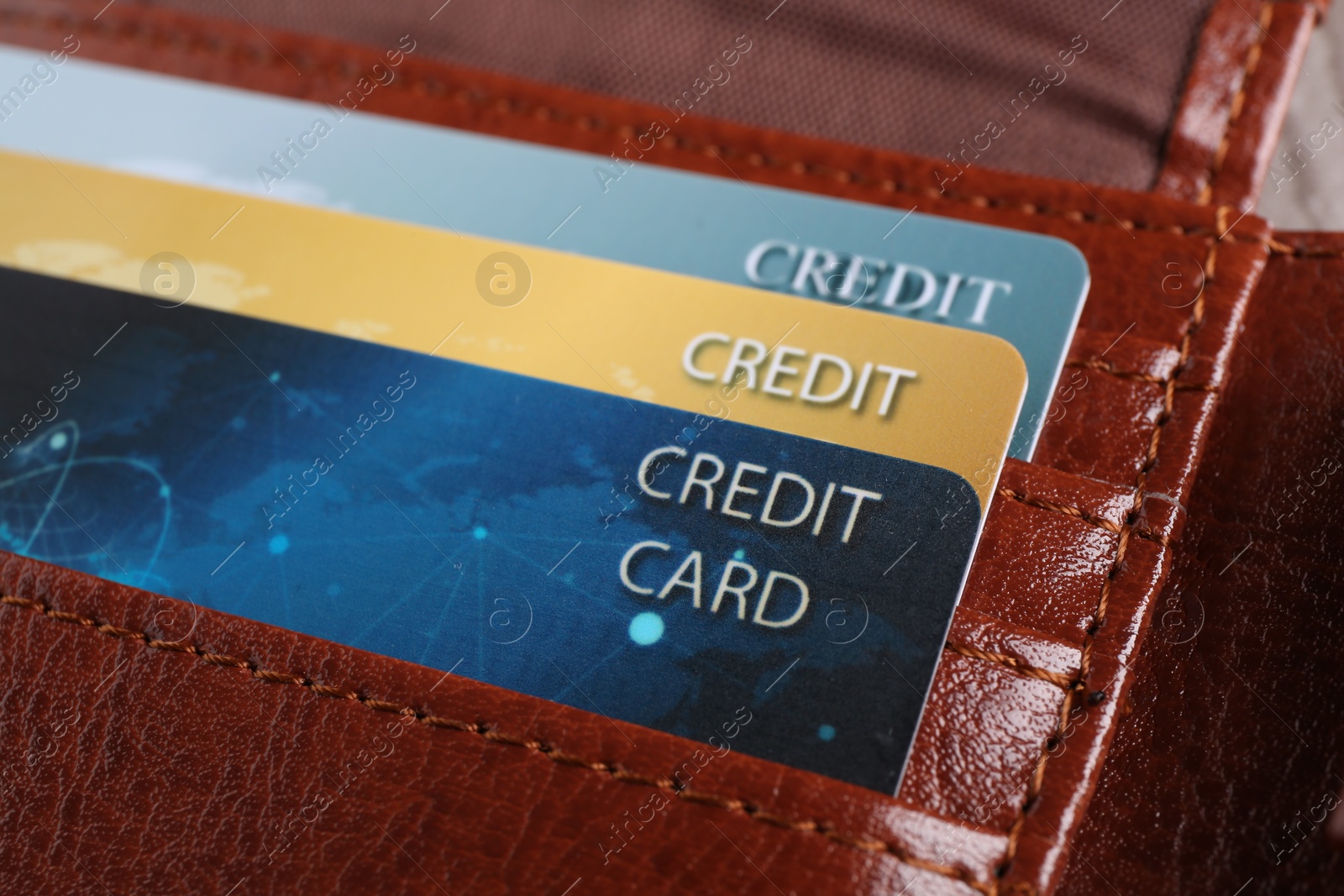 Photo of Credit cards in leather wallet on table, closeup