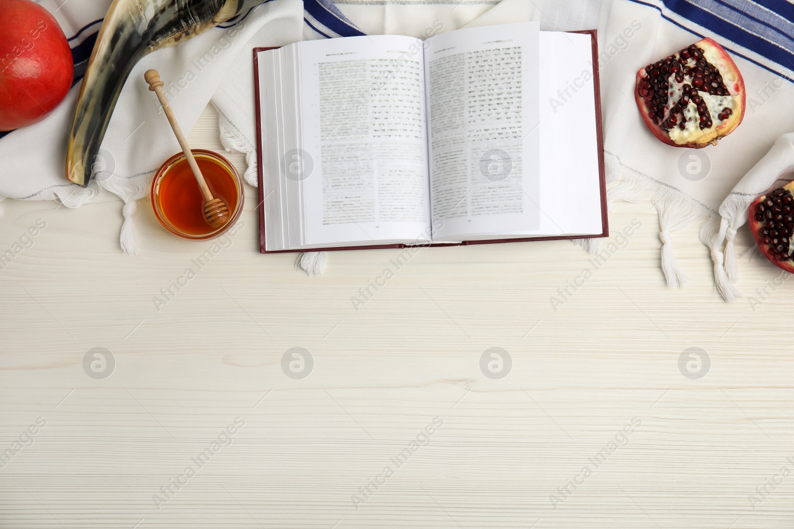 Photo of Flat lay composition with Rosh Hashanah holiday symbols on white wooden table. Space for text