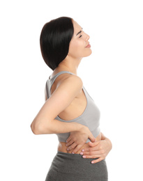 Photo of Woman suffering from lower back pain on white background. Visiting orthopedist