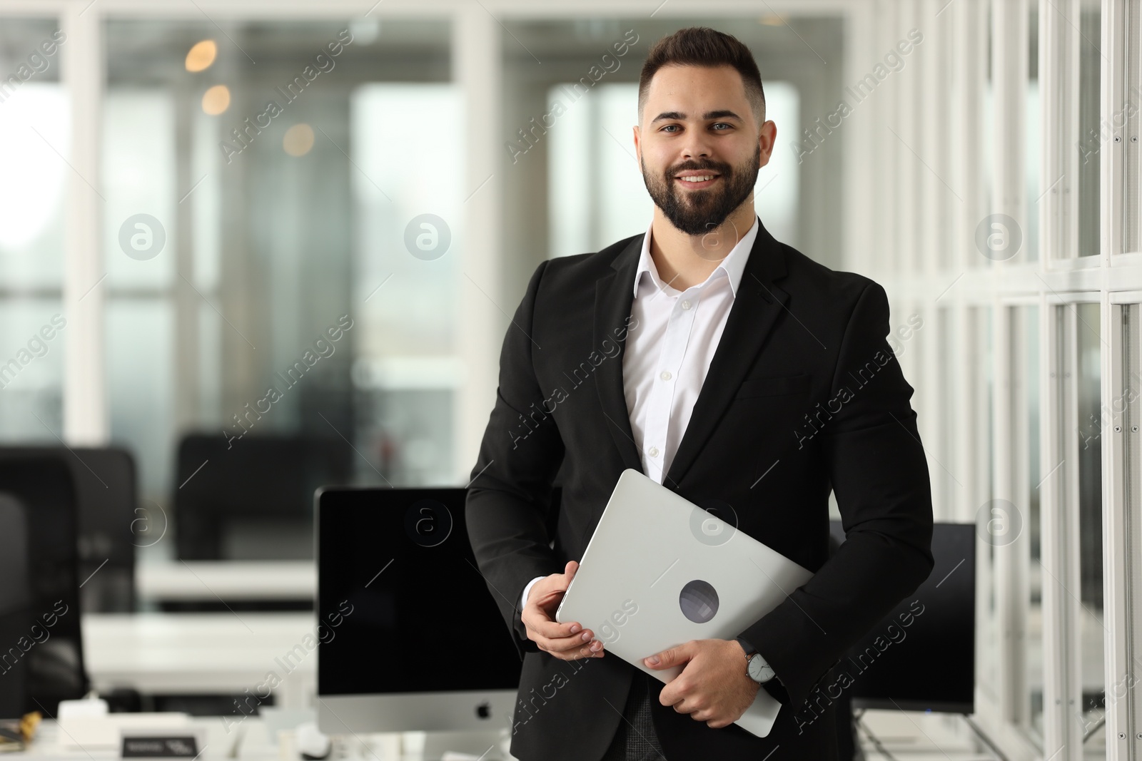 Photo of Portrait of smiling man with laptop in office, space for text. Lawyer, businessman, accountant or manager