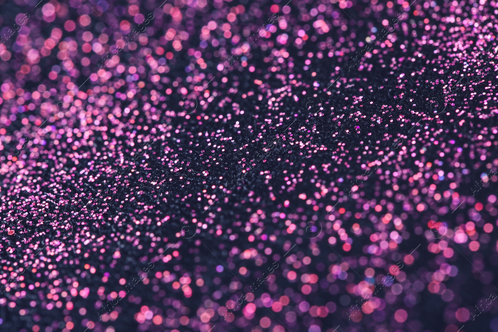 Photo of Pink glitter with bokeh effect on dark background