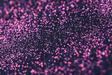 Photo of Pink glitter with bokeh effect on dark background