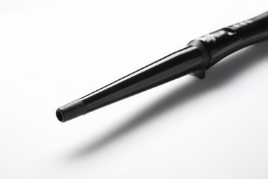 Photo of Modern clipless curling hair iron on white background