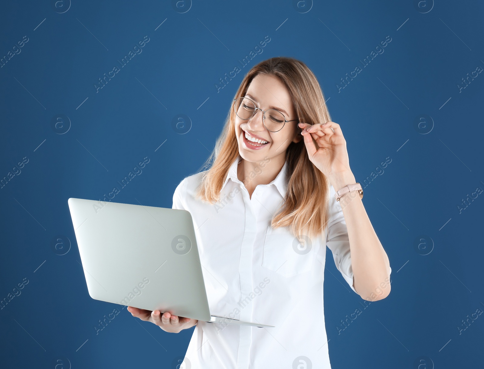 Photo of Portrait of young woman in office wear with laptop on color background