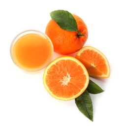 Photo of Orange juice, fresh fruits and green leaves on white background, top view