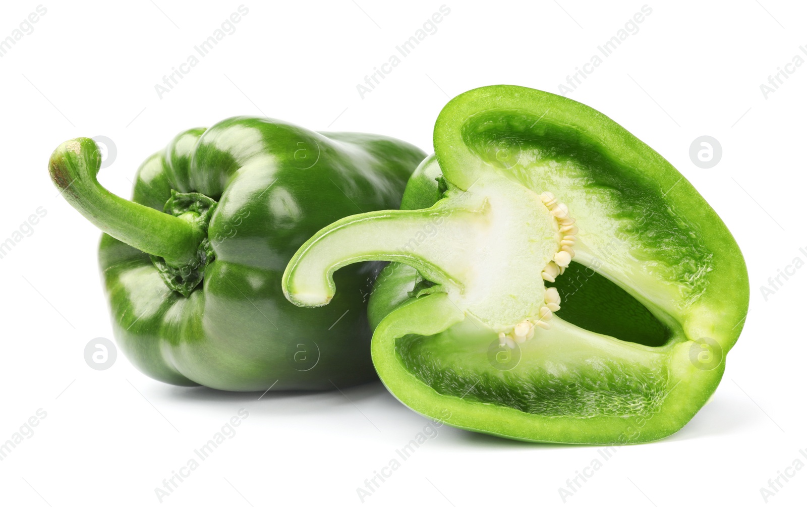 Photo of Cut and whole tasty green bell peppers on white background