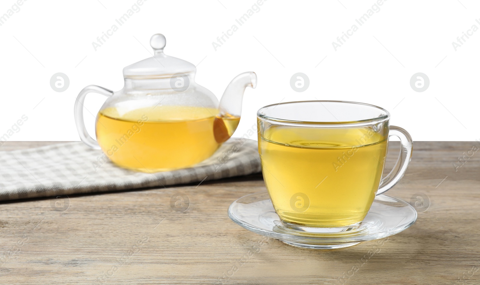 Photo of Refreshing green tea in cup and teapot on wooden table against white background