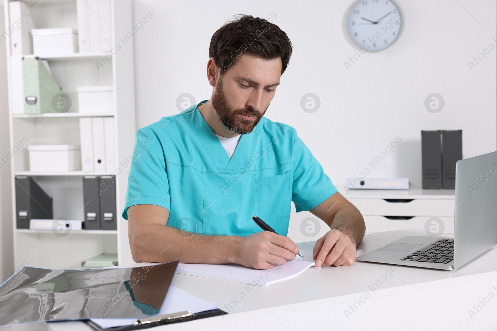 Photo of Doctor writing results from MRI scan in hospital