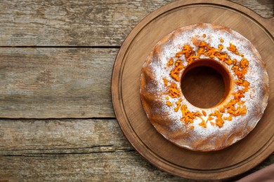 Photo of Homemade yogurt cake with tangerines and powdered sugar on wooden table, top view. Space for text