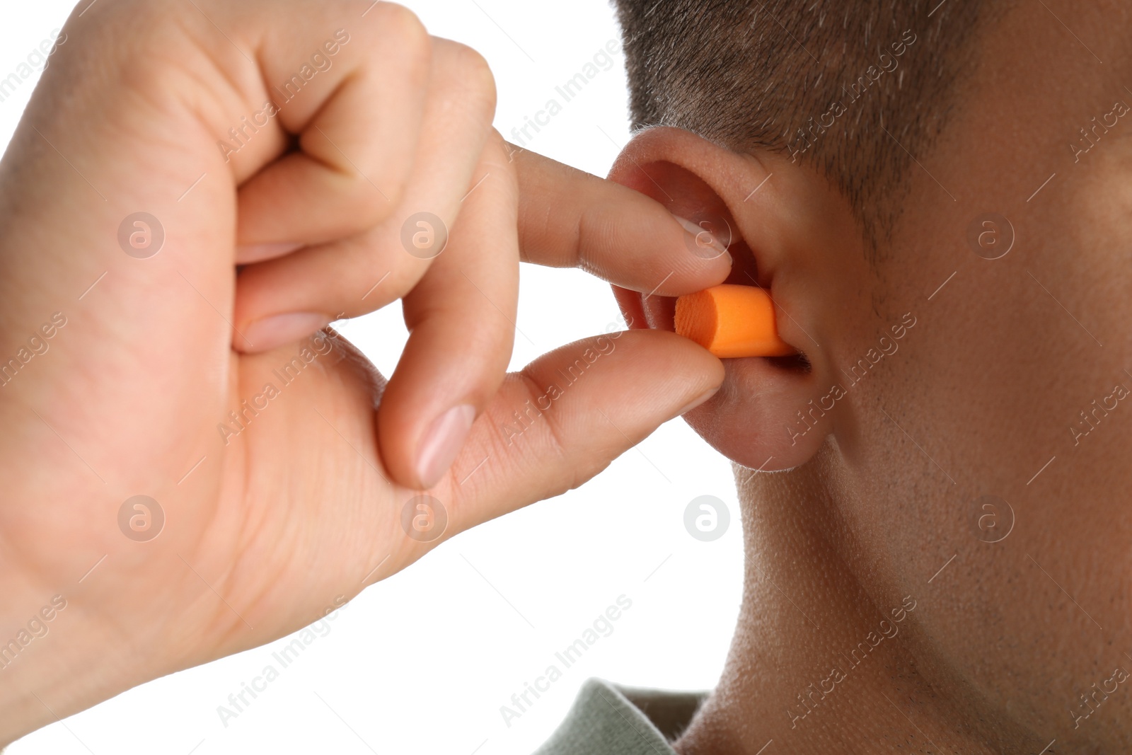 Photo of Man inserting foam ear plug on white background, closeup
