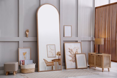 Photo of Light room interior with large mirror near wall