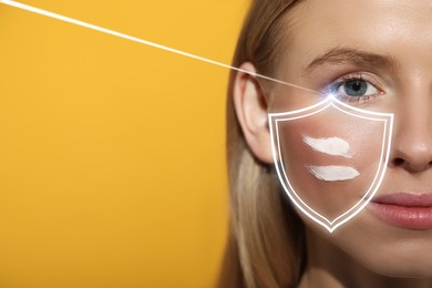 Sun protection care. Beautiful woman with sunscreen on face against golden background, space for text. Illustration of shield as SPF