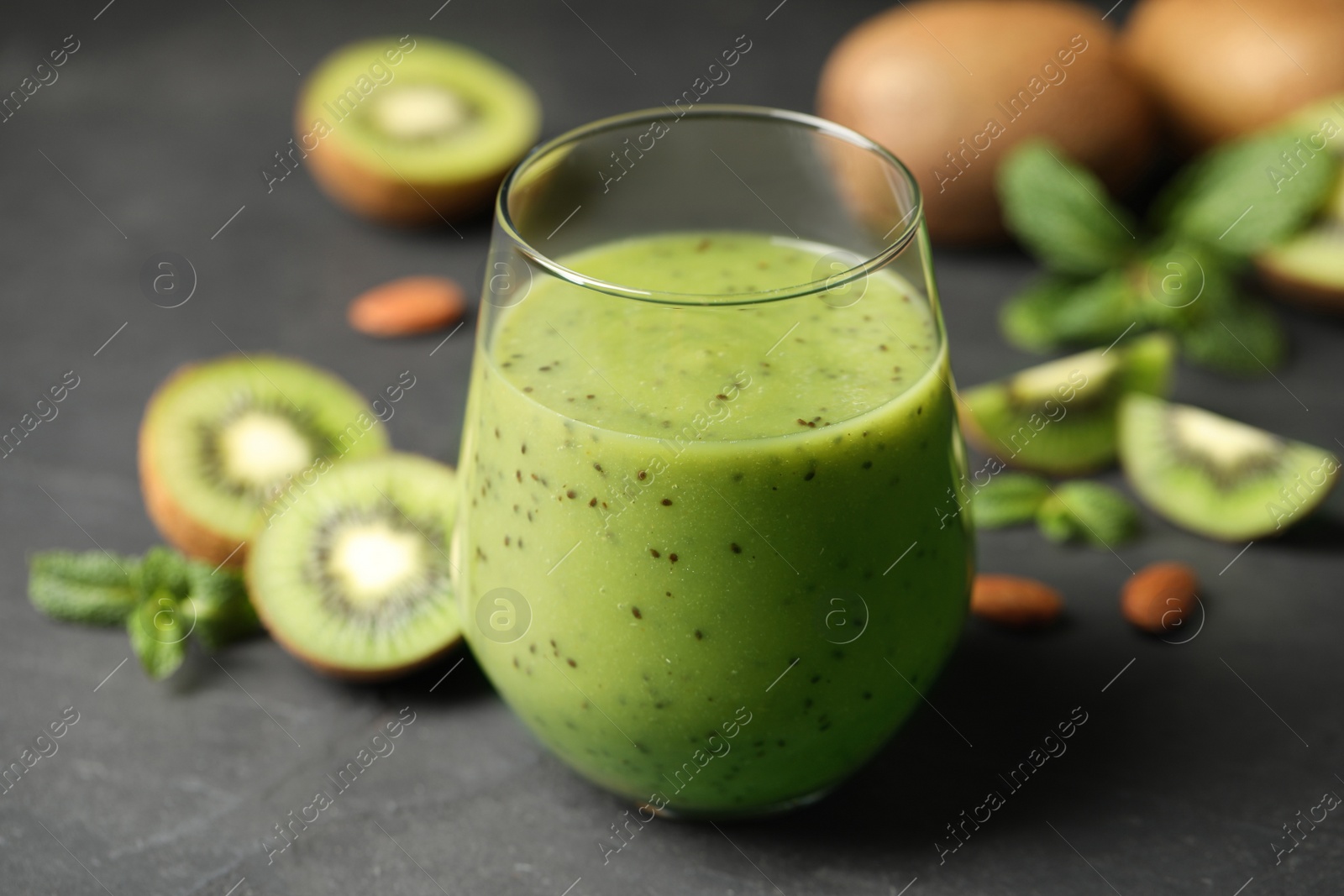Photo of Delicious kiwi smoothie and fresh fruits on grey table