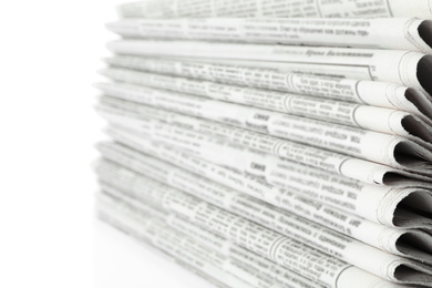 Photo of Stack of newspapers on white background, closeup. Journalist's work