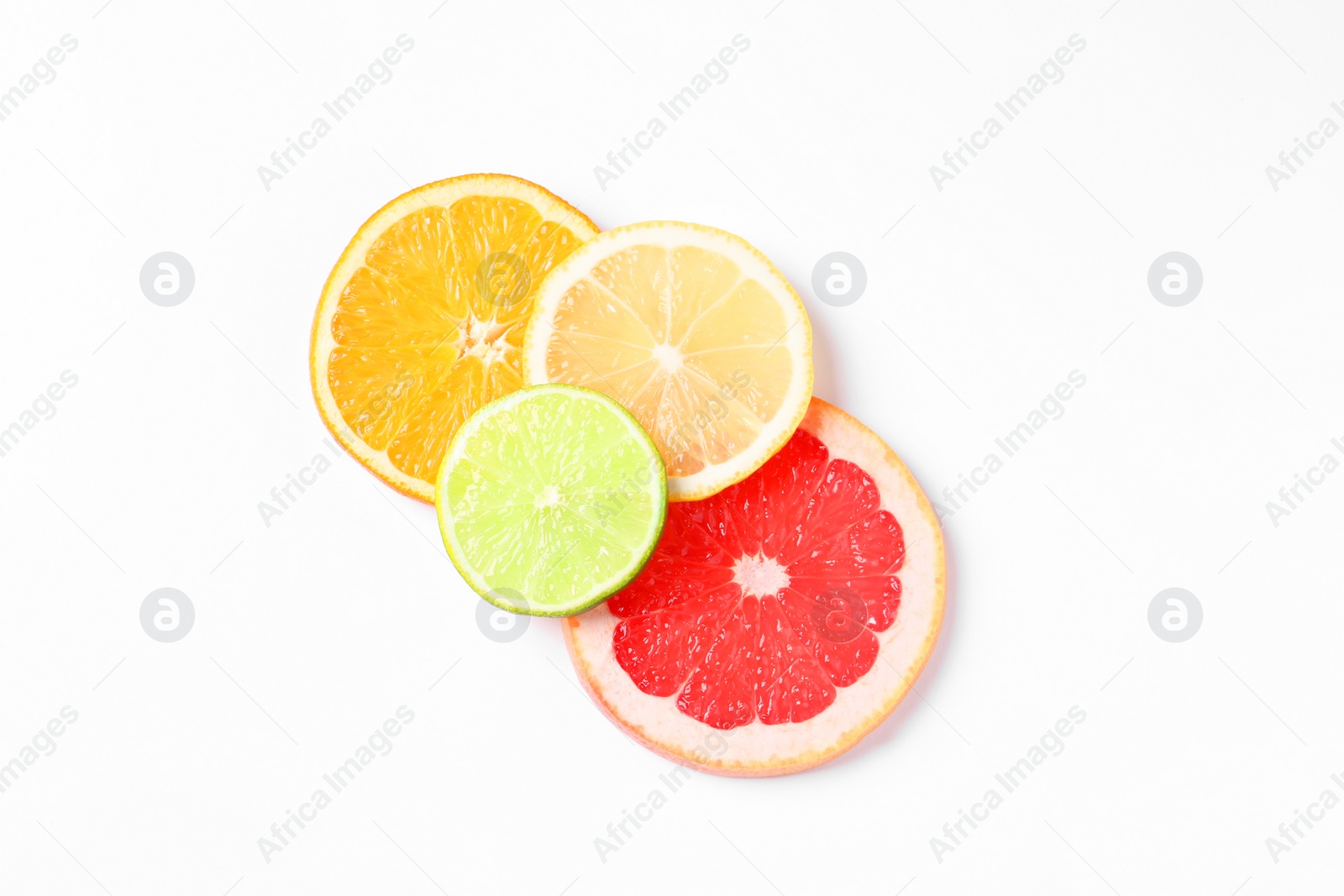 Photo of Slices of fresh ripe citrus fruits on white background, flat lay