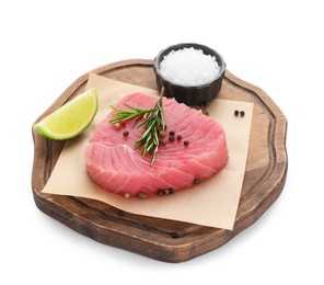 Photo of Raw tuna fillet with spices and lime wedge on white background