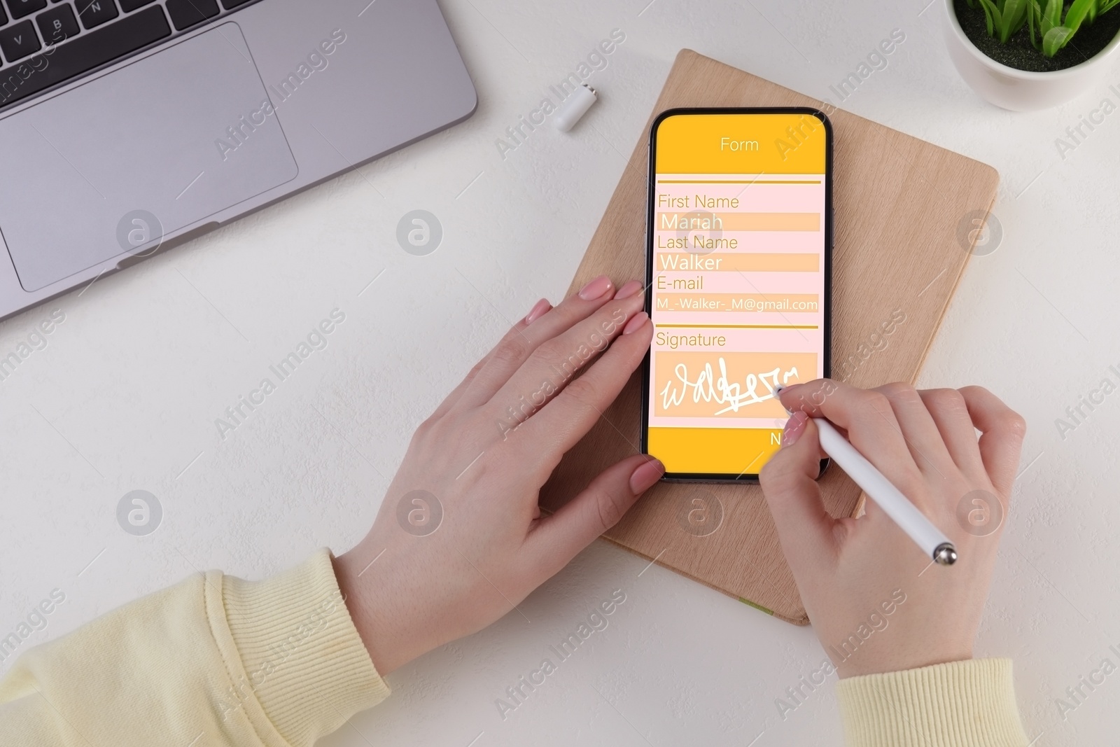 Image of Electronic signature. Woman using stylus and mobile phone at white table, top view