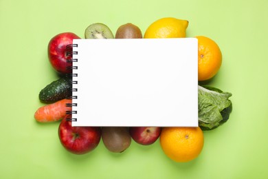 Photo of Notebook,, fresh fruits and vegetables on light green background, flat lay. Low glycemic index diet