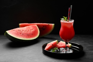 Tasty watermelon drink with mint on grey table