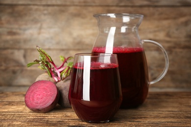 Freshly made beet juice on wooden table
