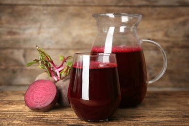 Photo of Freshly made beet juice on wooden table