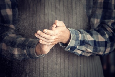 Photo of Man clapping hands and sprinkling flour, closeup