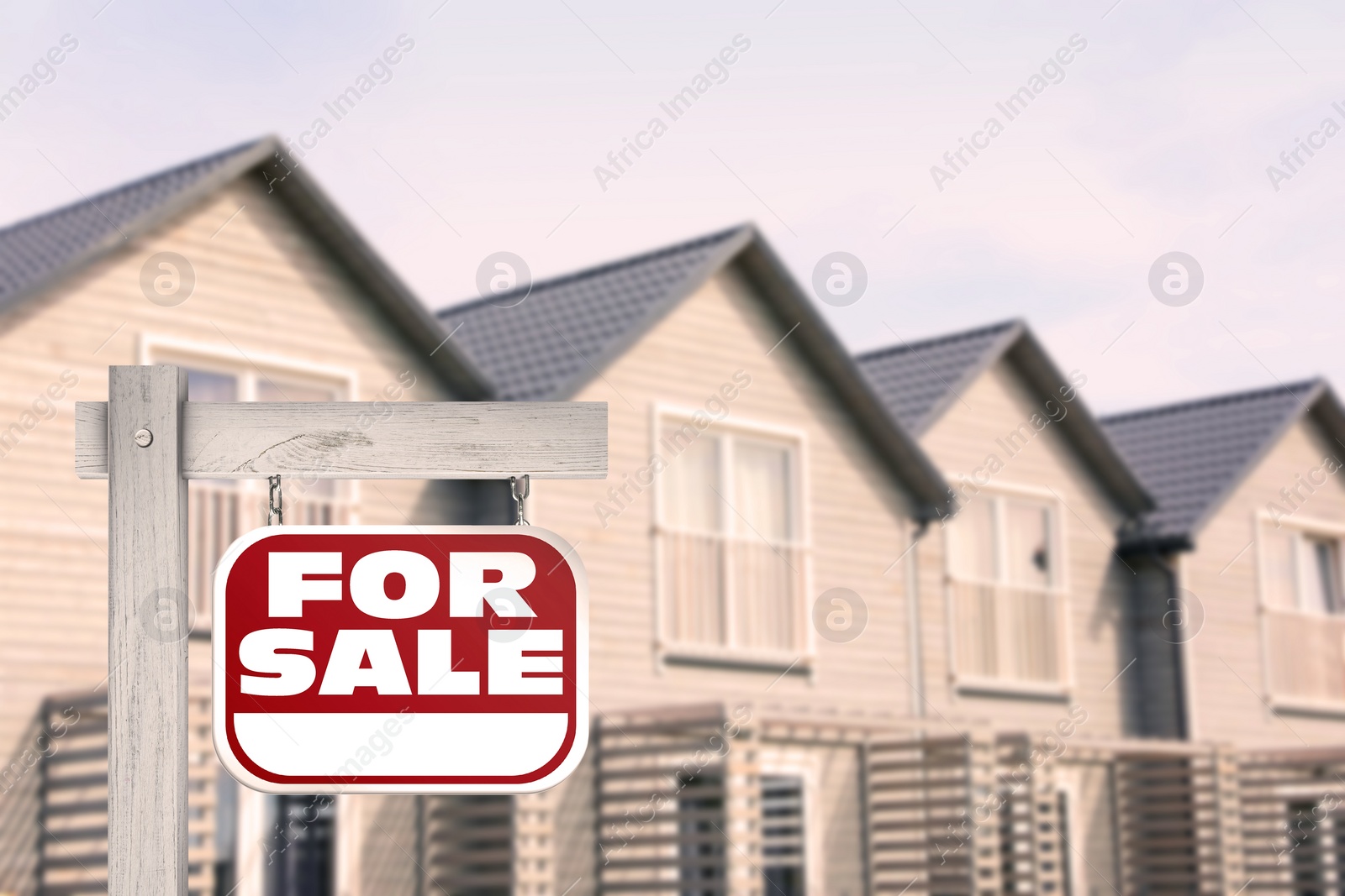 Image of Sale sign near beautiful house outdoors. Red signboard with words