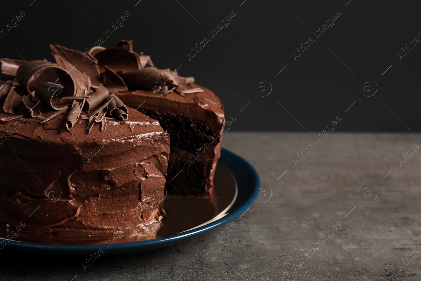 Photo of Tasty homemade chocolate cake on table. Space for text