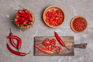 Photo of Flat lay composition with chili peppers on grey background