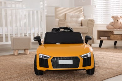 Photo of Yellow car in room at home. Child's toy