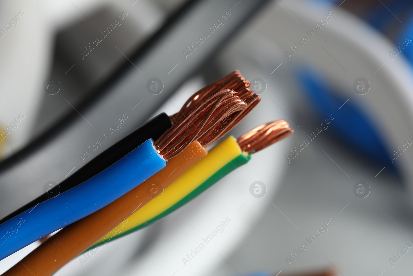 Photo of Colorful electrical wires on blurred background, closeup