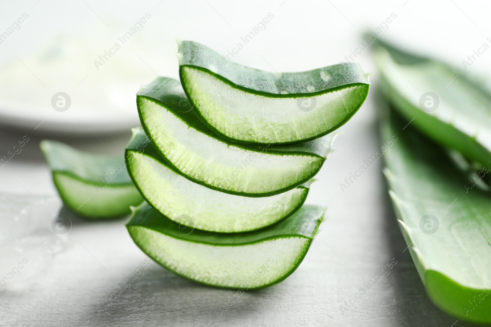 Photo of Fresh sliced aloe vera leaves on light background