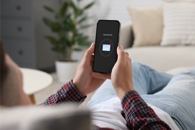 New message notification. Man with mobile phone indoors, closeup