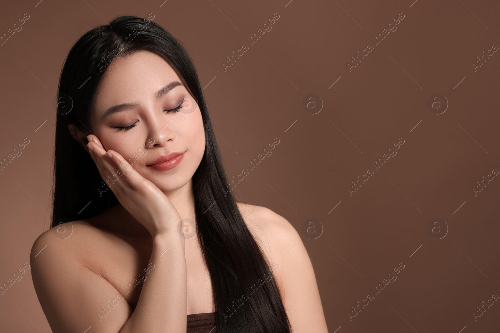 Photo of Portrait of beautiful woman on brown background, space for text