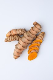 Photo of Fresh turmeric roots isolated on white, top view