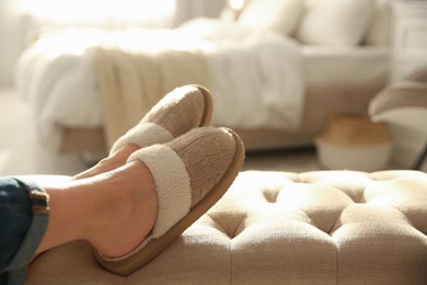 Photo of Woman wearing soft comfortable slippers at home, closeup. Space for text