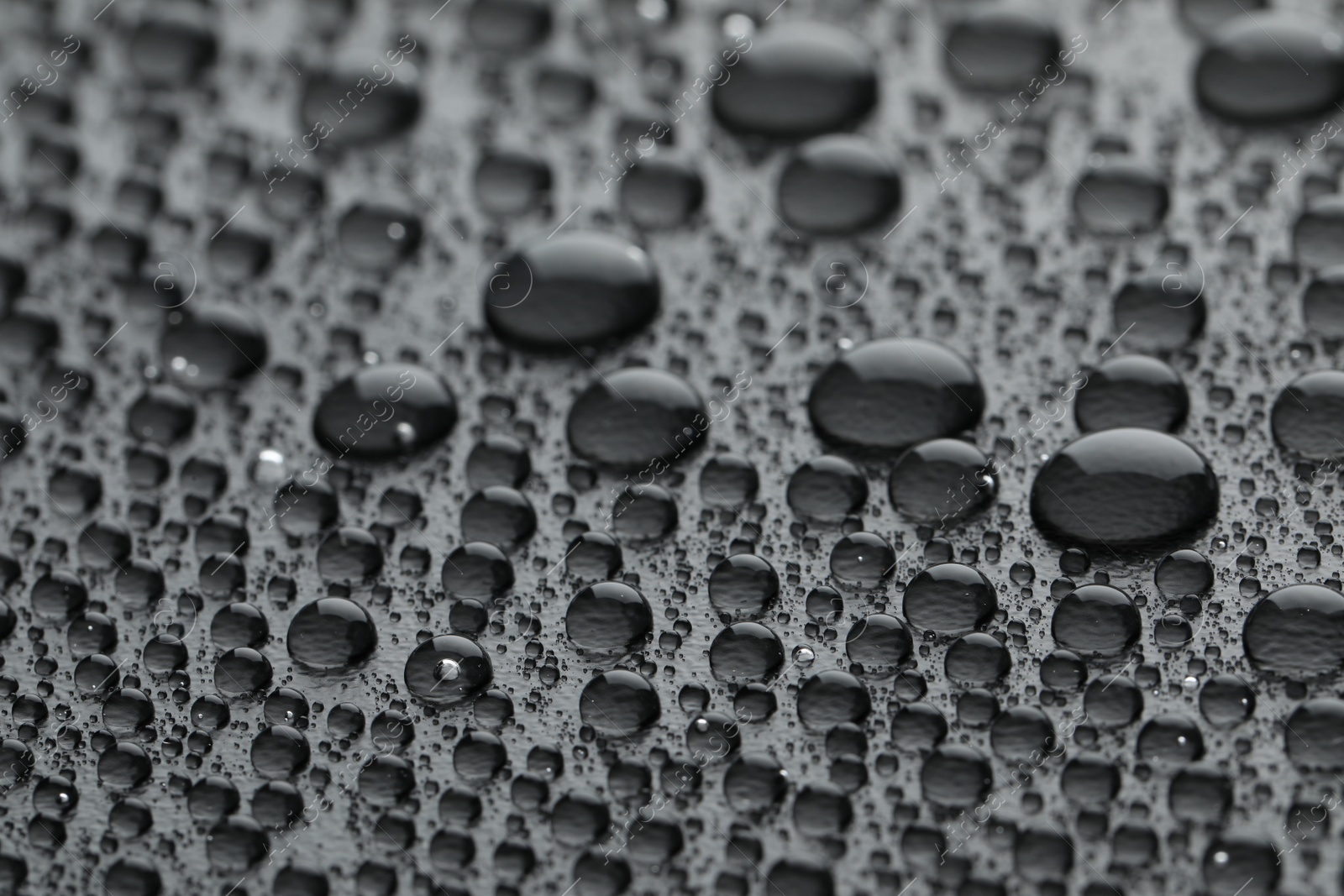 Photo of Water drops on grey background, closeup view