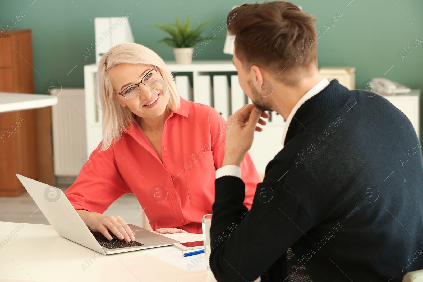 Photo of Mature woman consulting with man in office