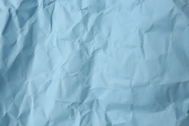 Photo of Sheet of crumpled light blue paper as background, top view