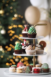 Photo of Many different Christmas cupcakes on white table indoors