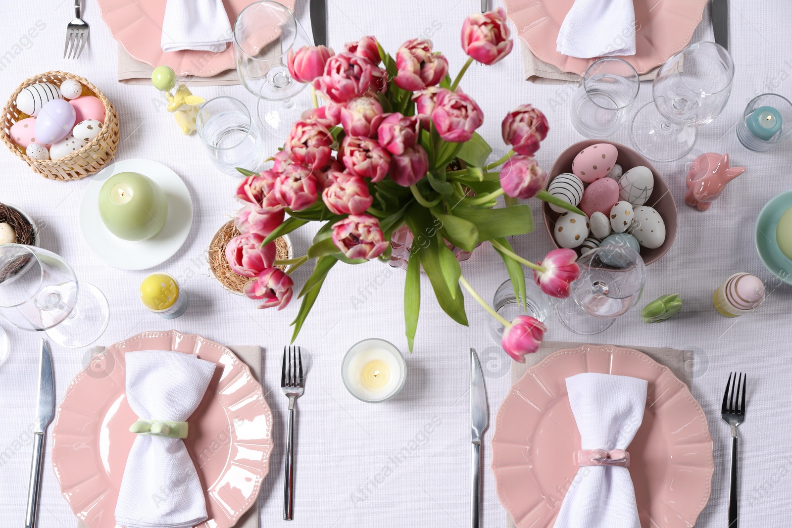 Photo of Festive table setting with beautiful flowers, flat lay. Easter celebration