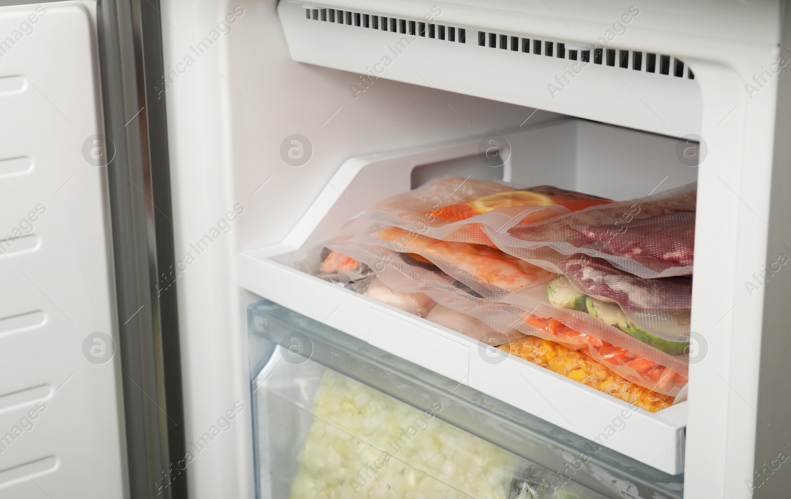 Photo of Vacuum bags with different products in fridge. Food storage