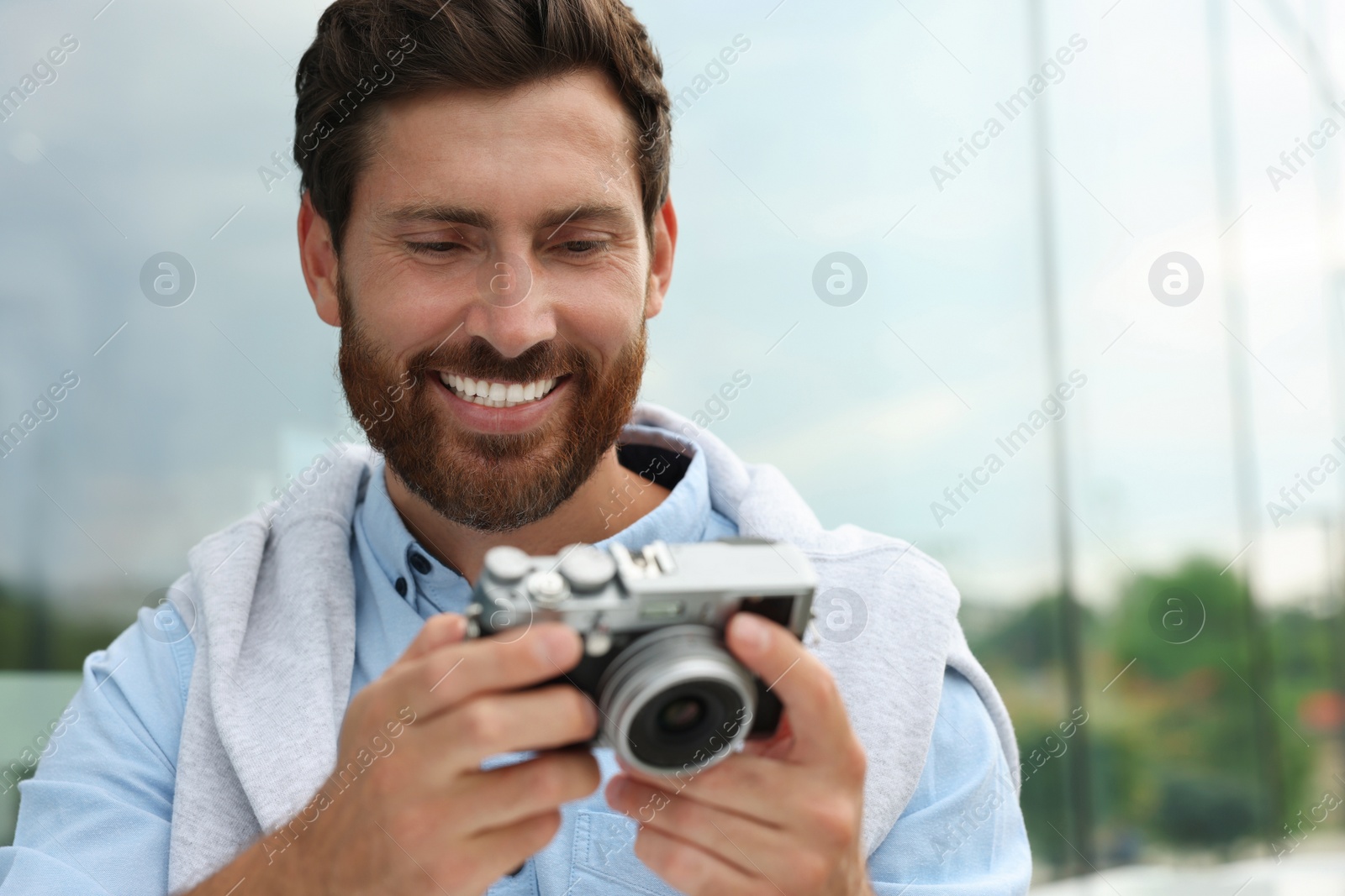 Photo of Man with camera outdoors, space for text. Interesting hobby