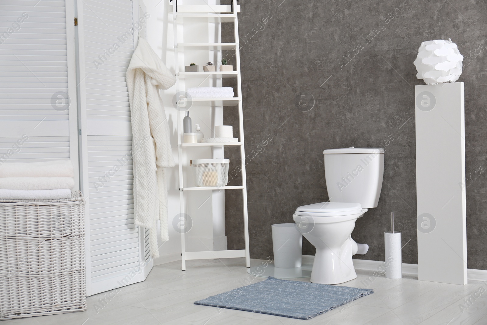 Photo of Ceramic toilet bowl in stylish bathroom. Idea for interior design