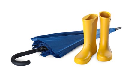 Photo of Yellow rubber boots and blue umbrella on white background
