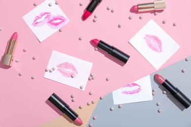 Photo of Flat lay composition with lipsticks on color background. Professional cosmetic products