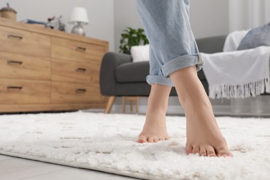 Photo of Woman standing on beige carpet in room, closeup. Space for text